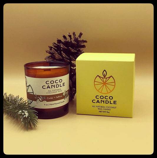 Coco Candle | An all-natural coconut wax candle hand poured into a sophisticated amber glass vessel enhanced by the soothing crackle of a wooden wick.  Fragrant cedar infused with the sensual smoky scents of patchouli and sandalwood, then topped with Eastern spices and a trace of white musk.