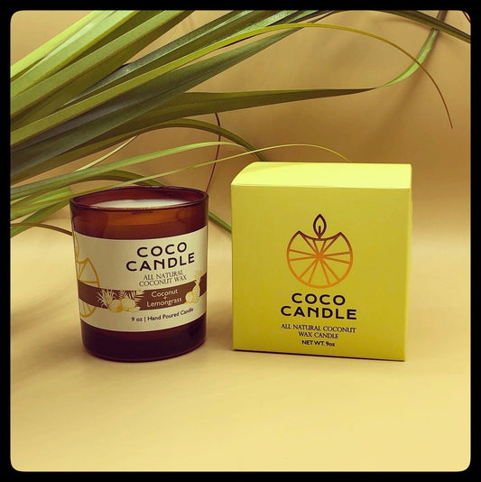 Coco Candle | An all-natural coconut wax candle hand poured into a sophisticated amber glass vessel enhanced by the soothing crackle of a wooden wick.  A blend of zesty lemongrass and fruity pineapple, with middle notes of lily of the valley and peach culminating in a smooth finish of coconut and sandalwood.
