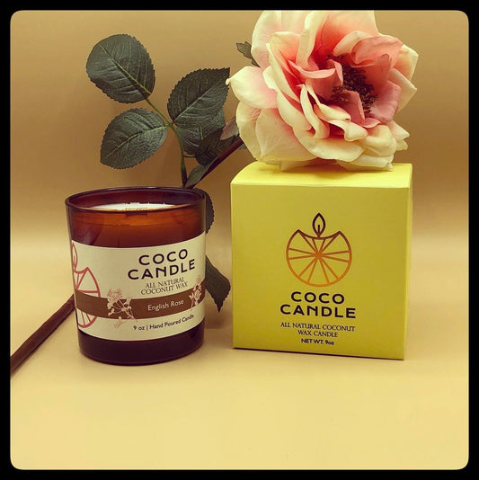 Coco Candle | An all-natural coconut wax candle hand poured into a sophisticated amber glass vessel enhanced by the soothing crackle of a wooden wick.  A light and delicate fragrance resembling a freshly picked dewy rose.  This fragrance is so divine even your rose garden will be jealous!