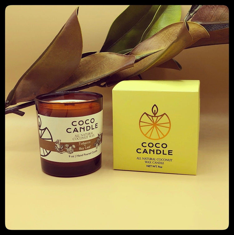 Coco Candle | An all-natural coconut wax candle hand poured into a sophisticated amber glass vessel enhanced by the soothing crackle of a wooden wick.  Top notes of bay leaf and fir needle mingle with cedarwood and crisp bergamot to reveal a warm tobacco base note.  This fragrance has a fresh, clean aroma with well-balanced natural notes.